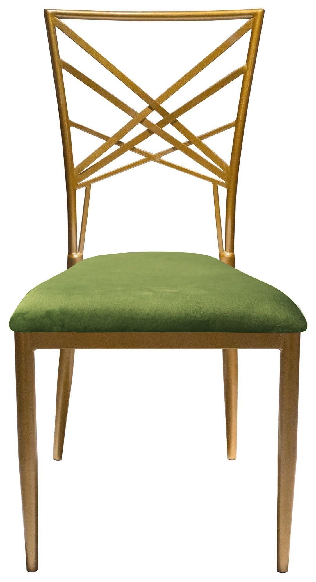 Gold lattice-back chair with a vibrant grass-green velvet seat arranged around a round table with gold accents and natural décor.