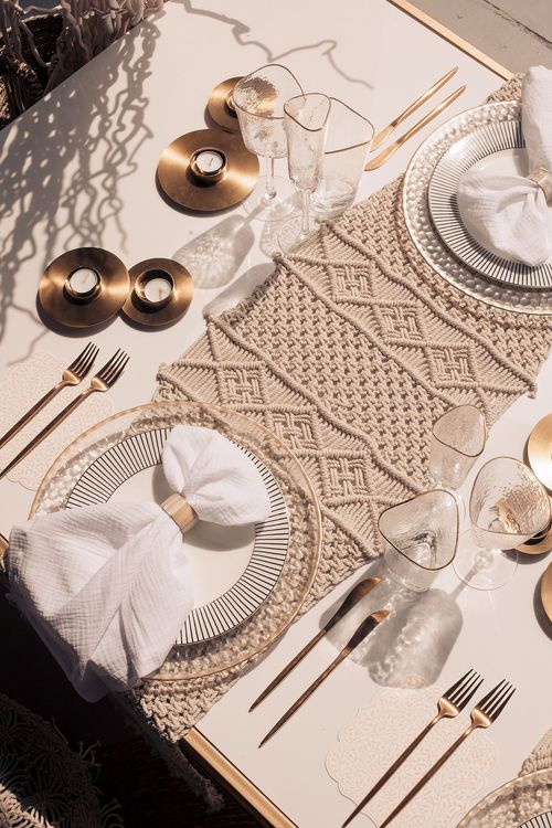 Beige boho table setting with ottomans
