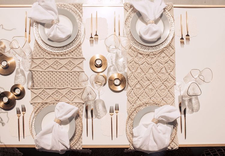 Beige boho table setting with ottomans