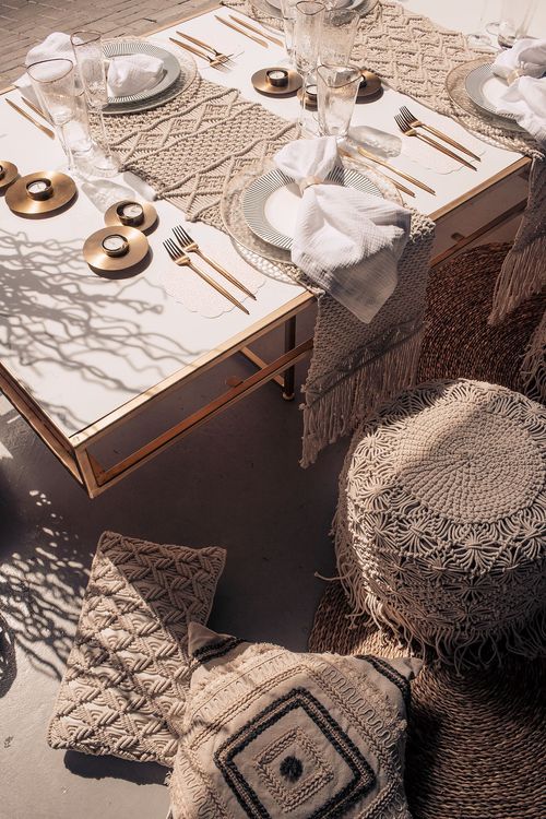Beige boho table setting with ottomans