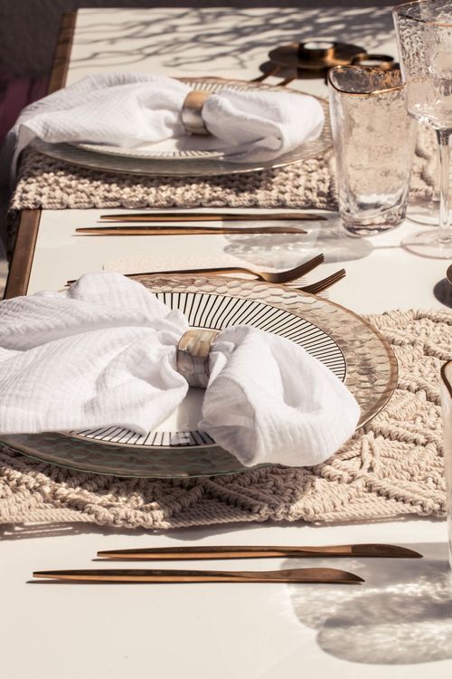 Beige boho table setting with ottomans