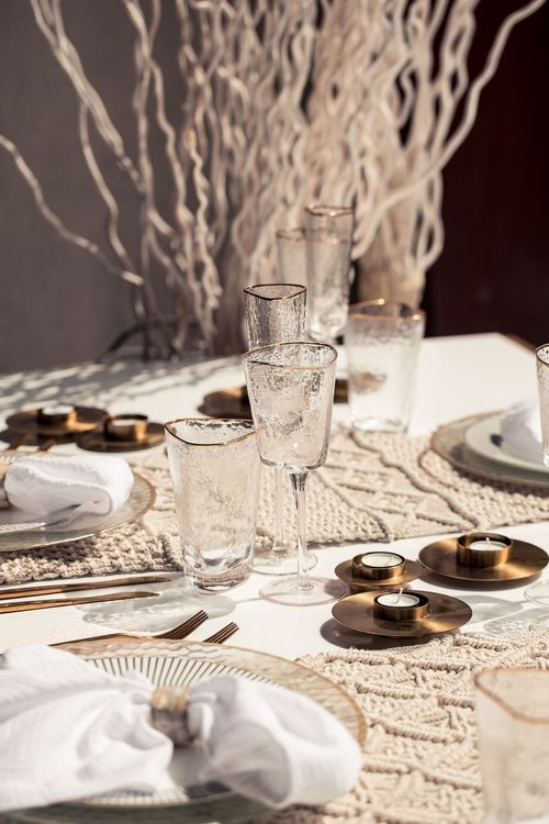 Beige boho table setting with ottomans