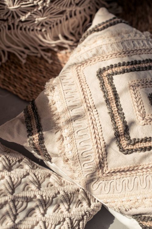 Beige boho table setting with ottomans