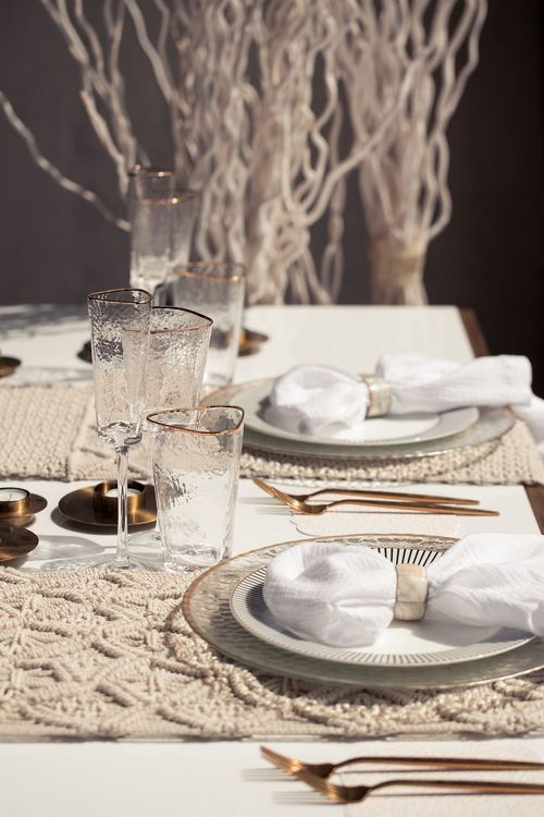 Beige boho table setting with ottomans