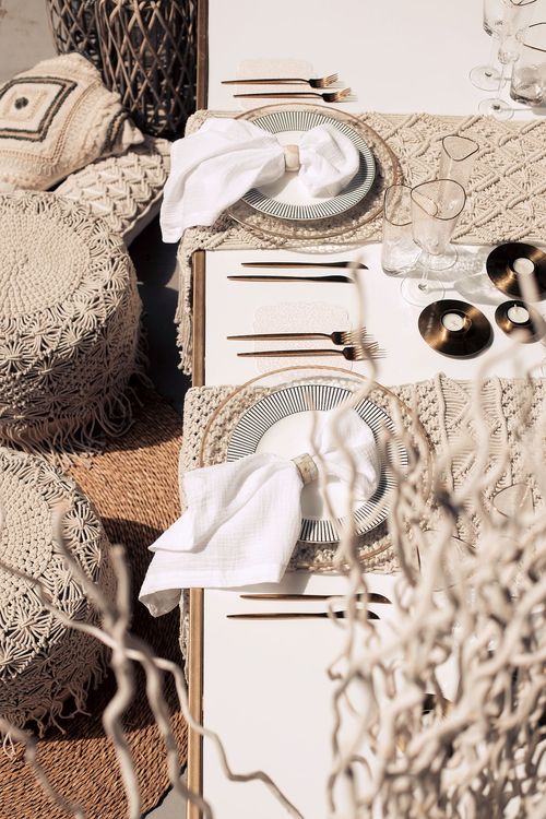 Beige boho table setting with ottomans