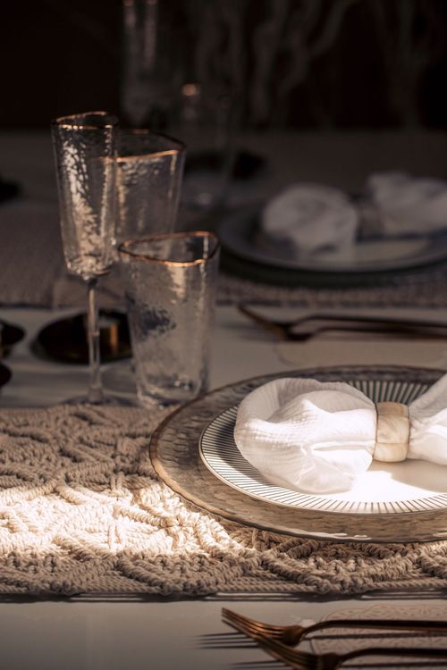 Beige boho table setting with ottomans