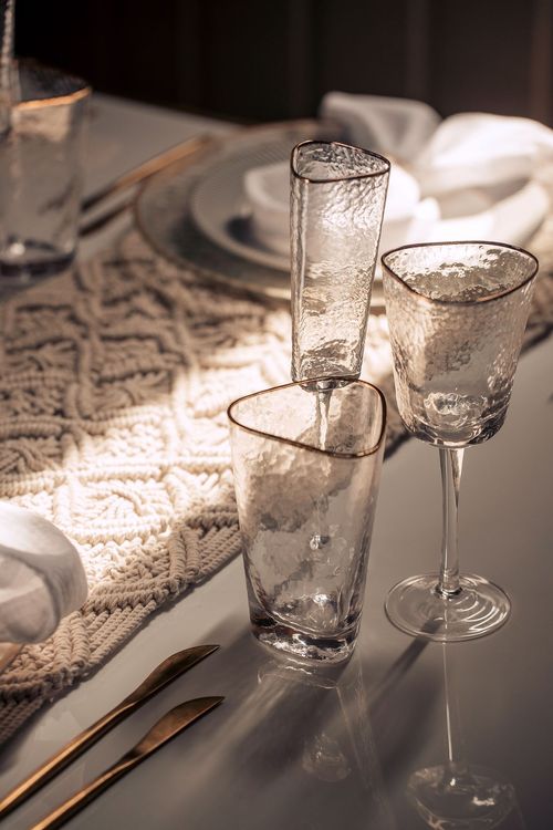 Beige boho table setting with ottomans