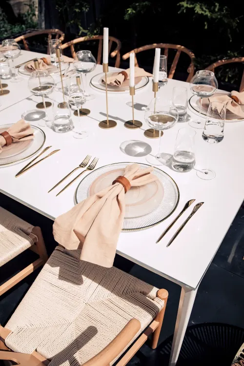 Beige set with boho accents on a white rectangular table