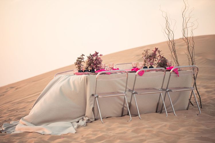 Beige desert  tablescape with fuchsia accents