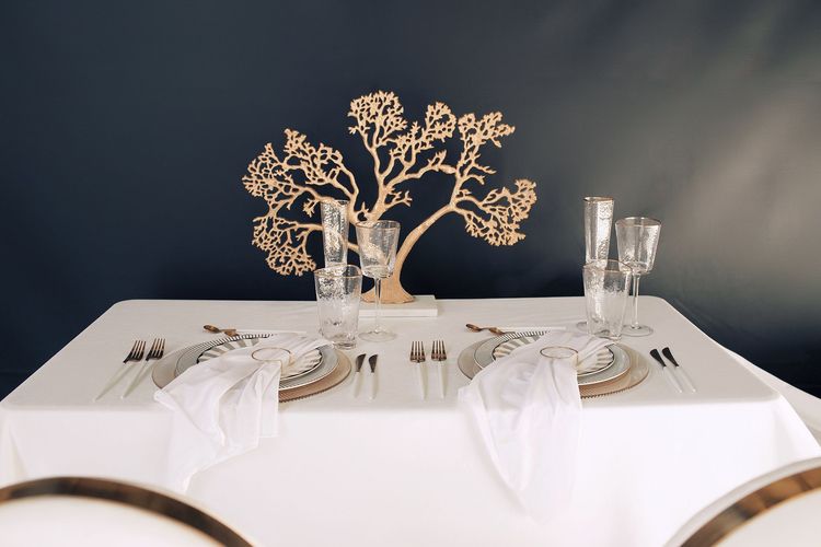 White set with gold accents on a rectangular table