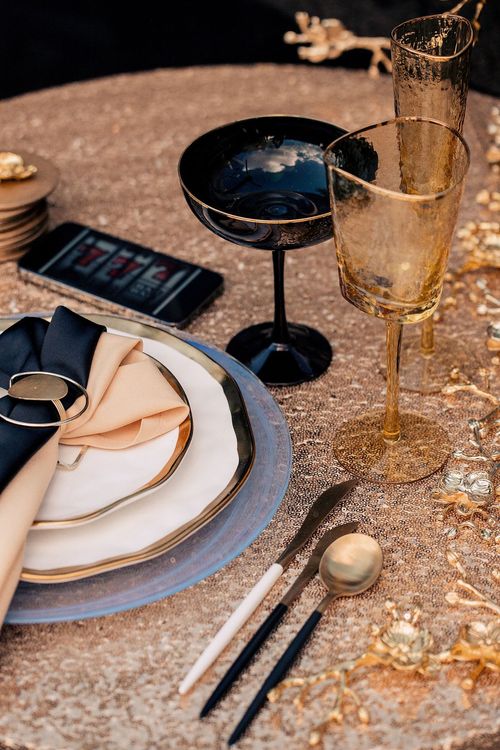 Black-gold table setting at round table