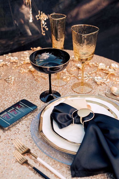 Black-gold table setting at round table