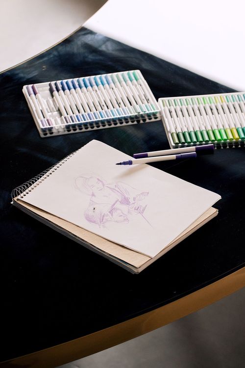 Black and white serpentine tables with velvet poufs