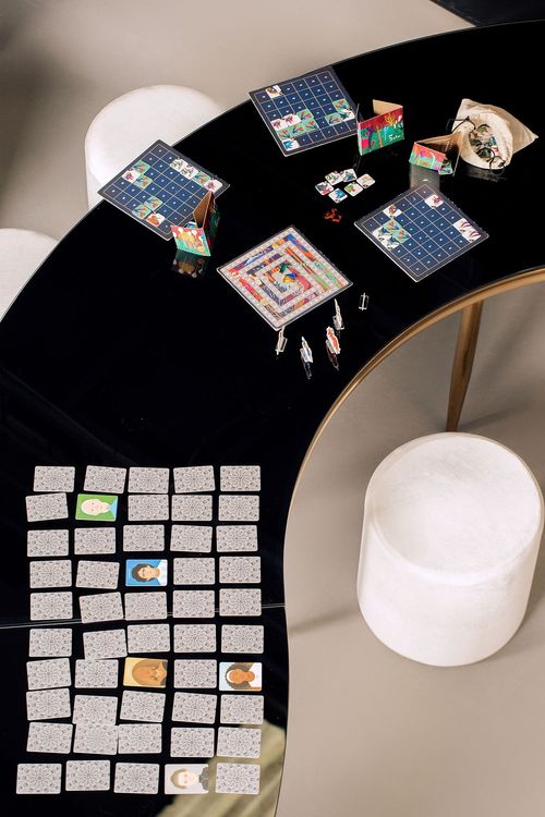 Black and white serpentine tables with velvet poufs