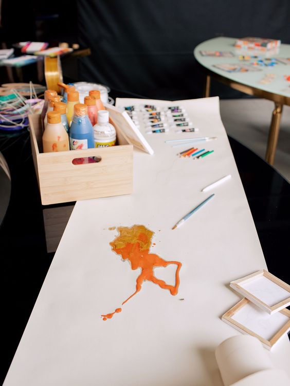 Black and white serpentine tables with velvet poufs