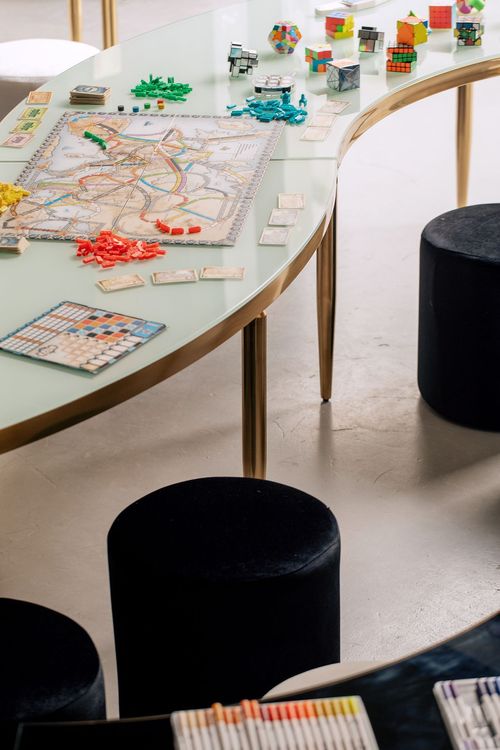 Black and white serpentine tables with velvet poufs