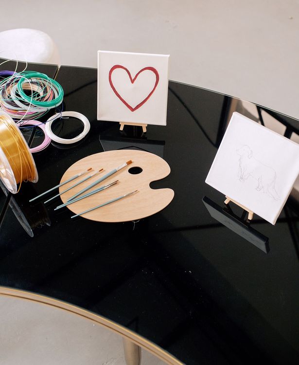 Black and white serpentine tables with velvet poufs