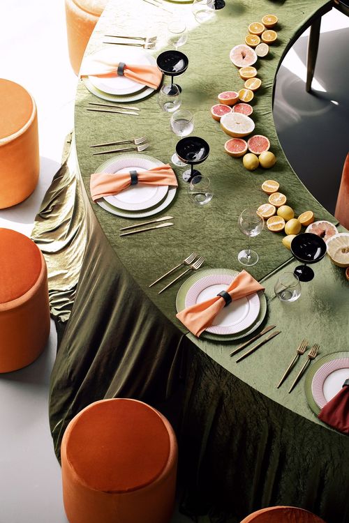Orange green serpentine table set with poufs