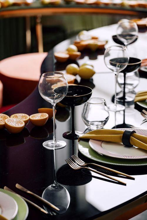 Orange green serpentine table set with poufs