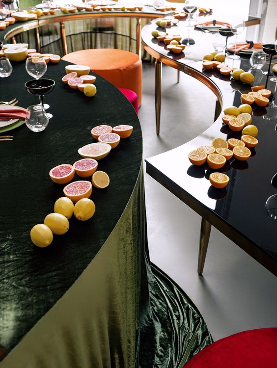 Orange green serpentine table set with poufs