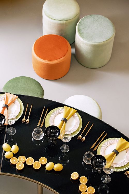 Orange green serpentine table set with poufs