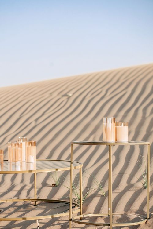 Pink desert lounge setup with ottomans