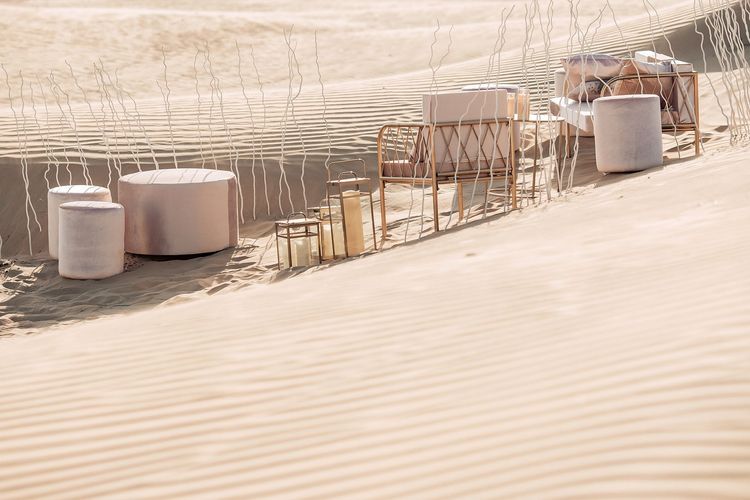 Pink desert lounge setup with ottomans