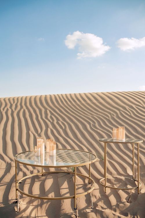 Pink desert lounge setup with ottomans