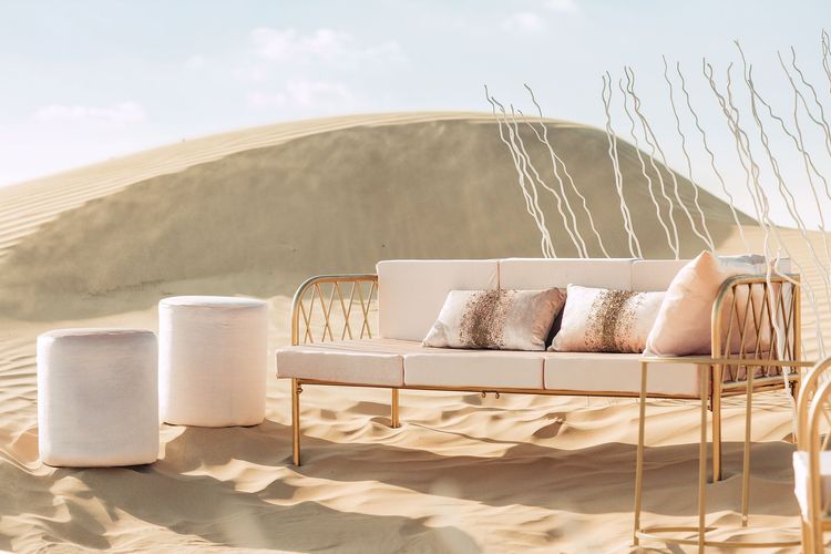 Pink desert lounge setup with ottomans