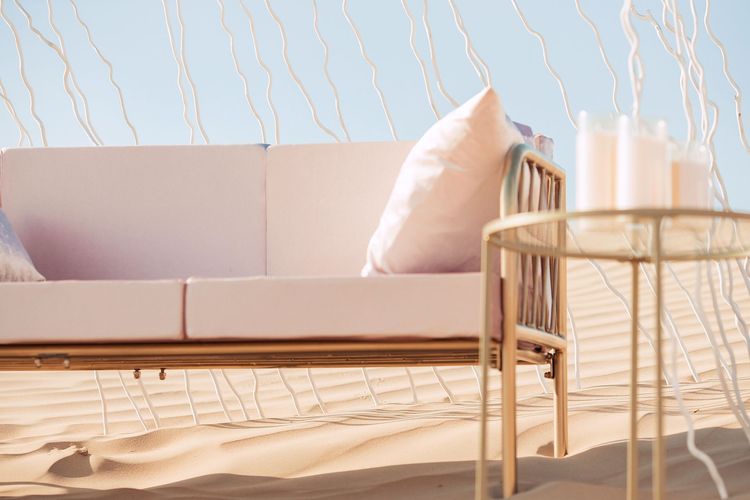 Pink desert lounge setup with ottomans
