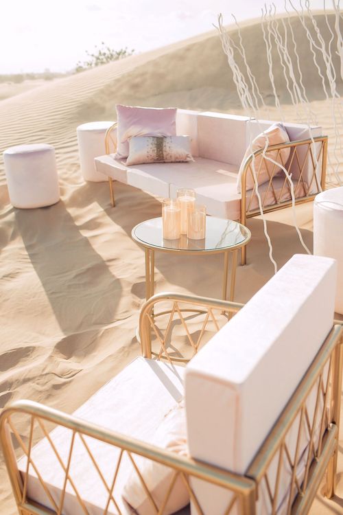 Pink desert lounge setup with ottomans