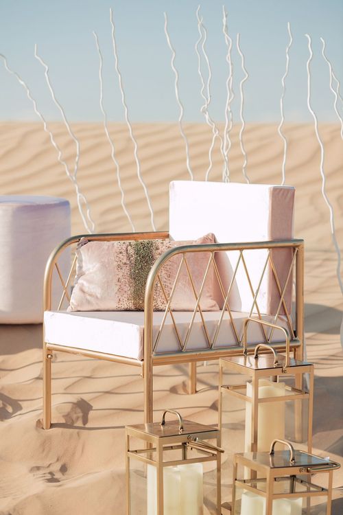 Pink desert lounge setup with ottomans