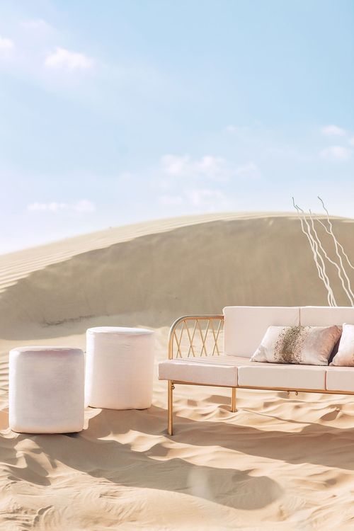 Pink desert lounge setup with ottomans