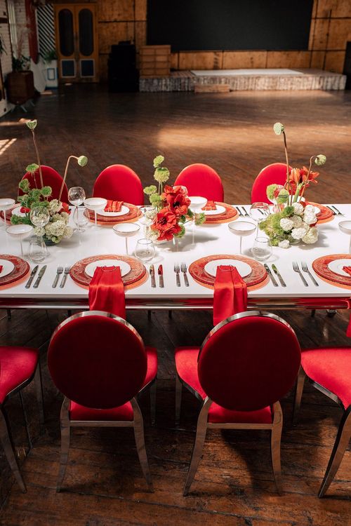 Red table setting at rectangular table