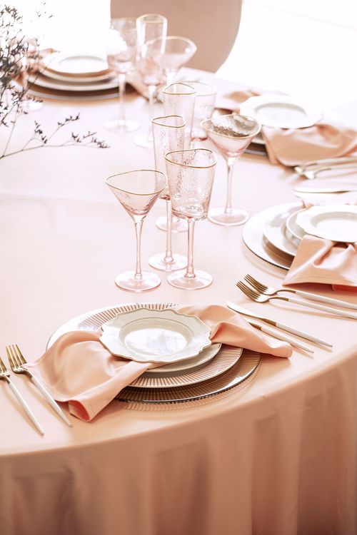 Soft pink table setting at round table