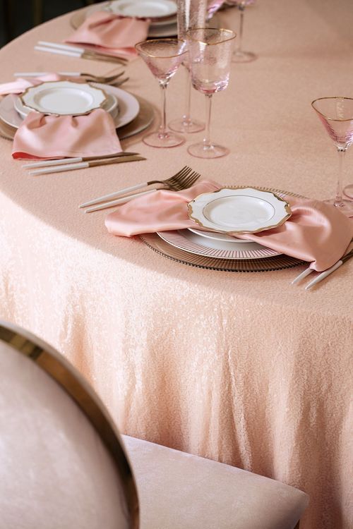 Soft pink table setting at round table
