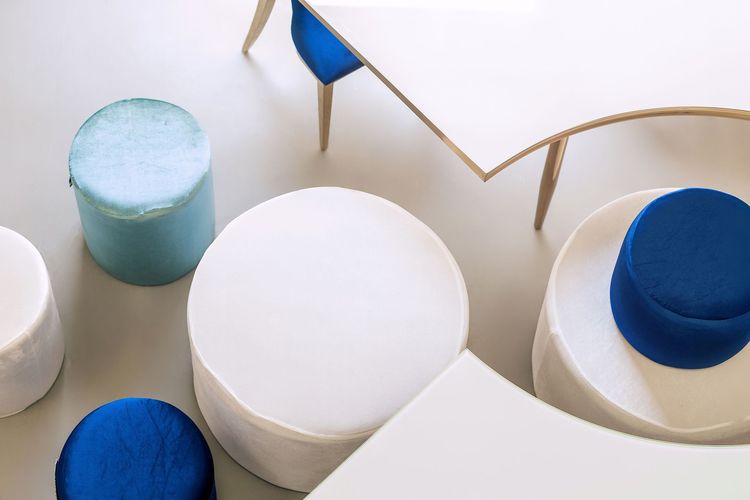 Eye-shaped table with a setup featuring blue accents
