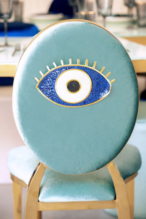 Eye-shaped table with a setup featuring blue accents