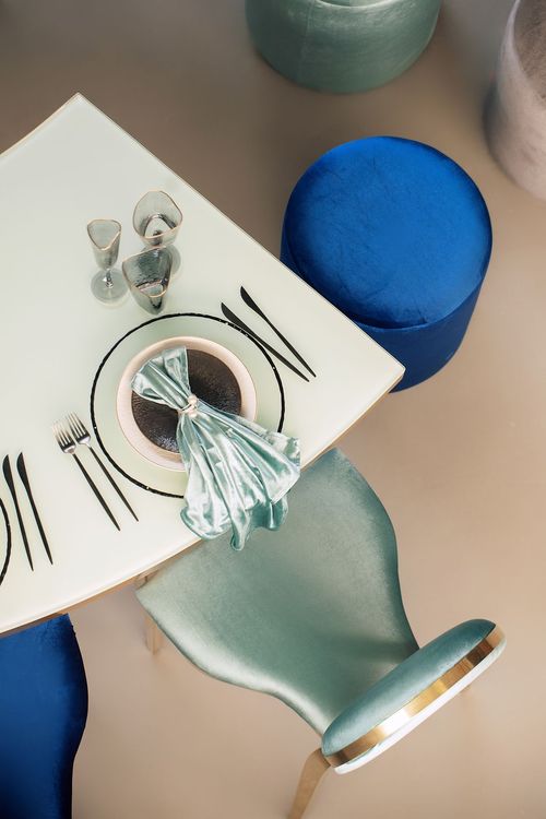 Eye-shaped table with a setup featuring blue accents