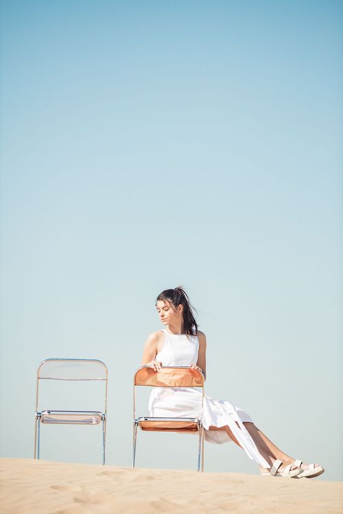 Transparent folding chairs desert