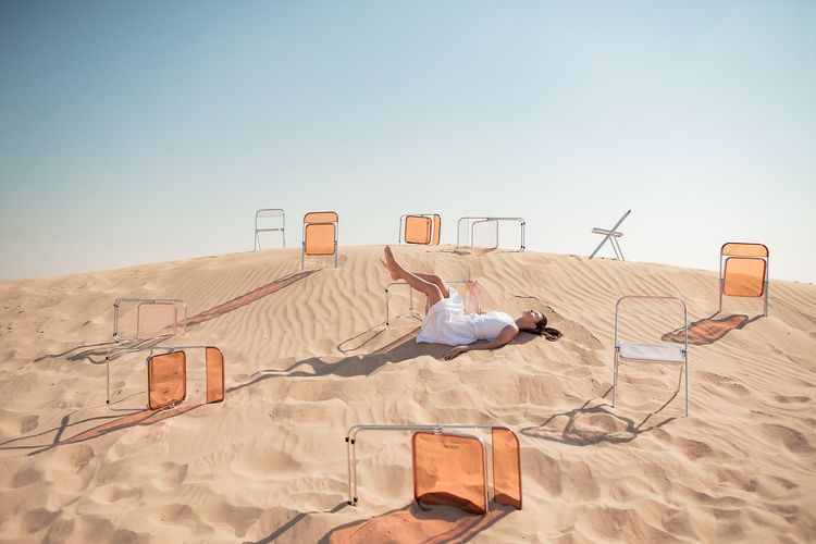 Transparent folding chairs desert