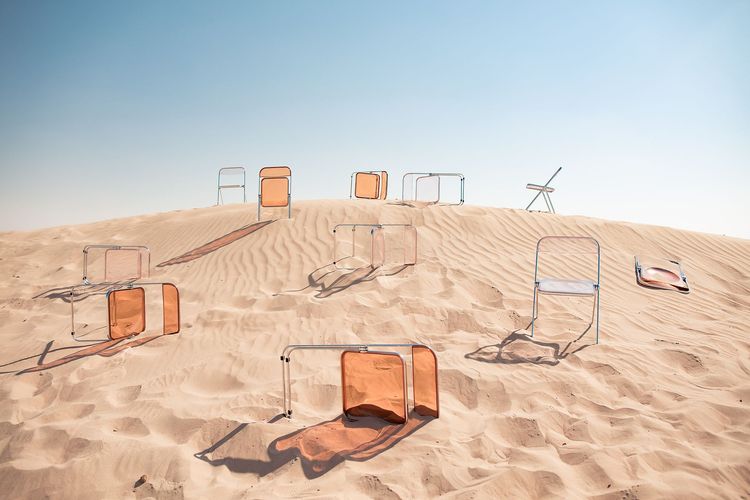 Transparent folding chairs desert