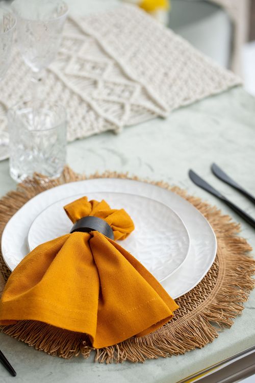Yellow-orange table setting at rectangular table