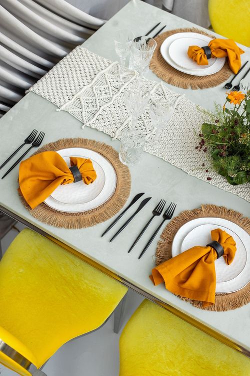 Yellow-orange table setting at rectangular table