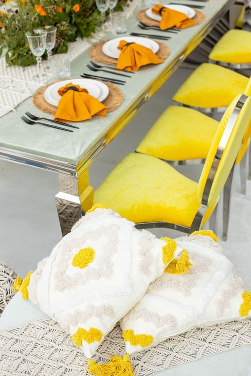 Yellow-orange table setting at rectangular table