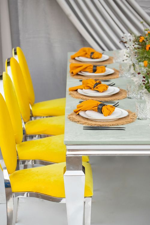 Yellow-orange table setting at rectangular table