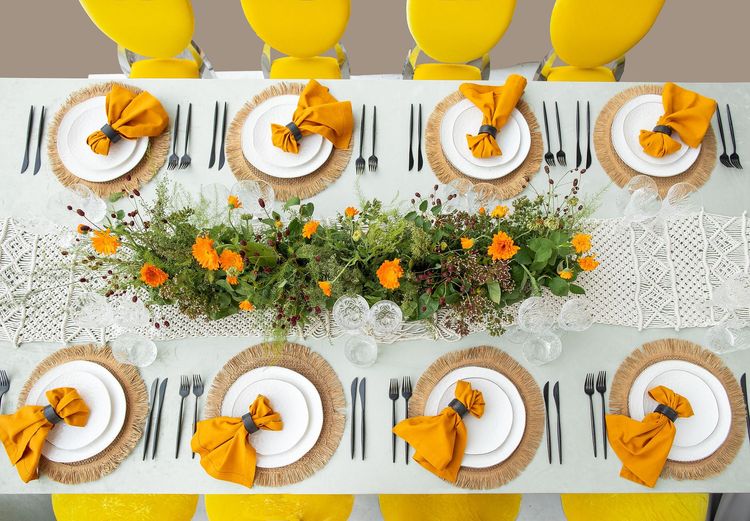 Yellow-orange table setting at rectangular table
