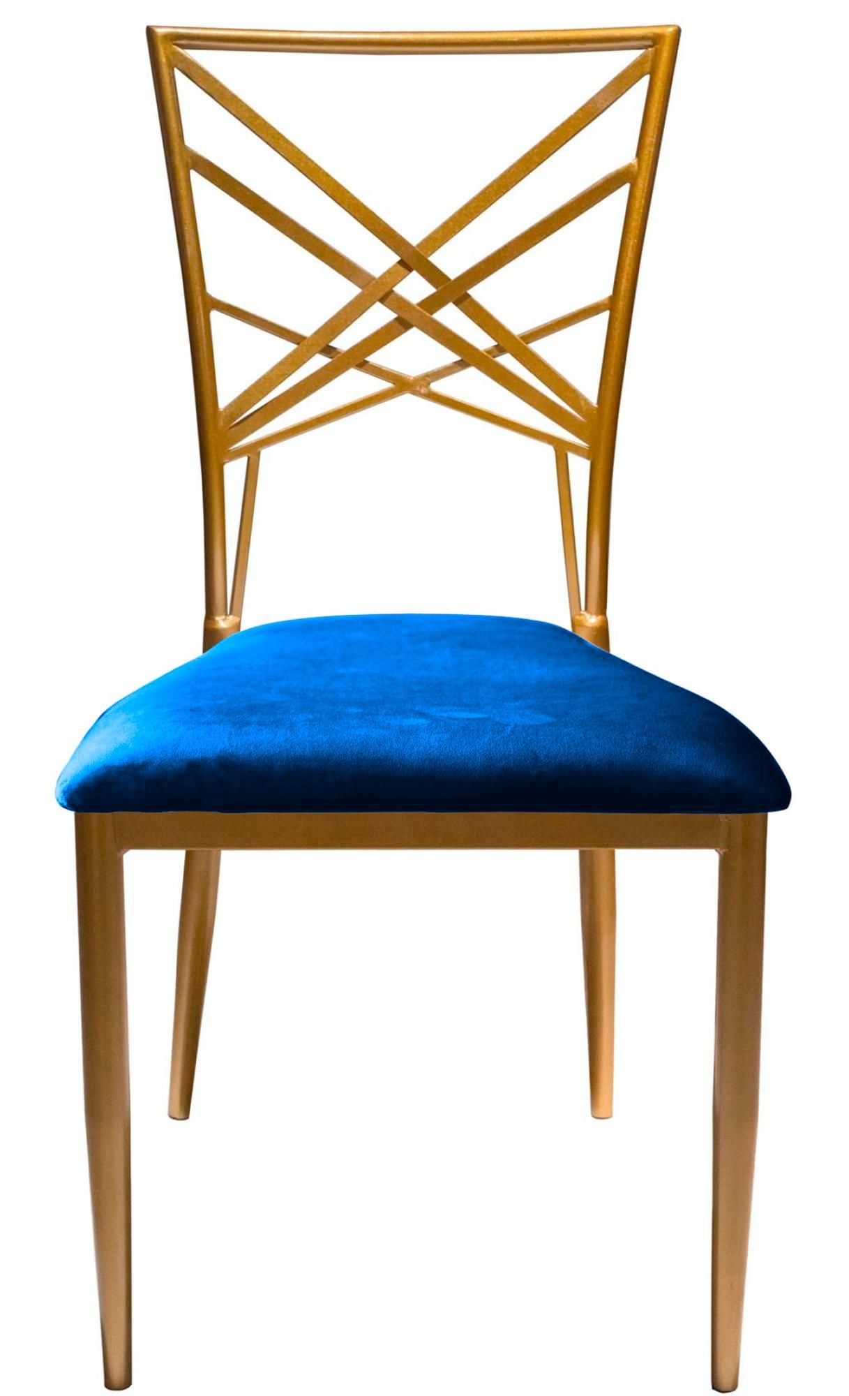 Gold lattice-back chair with a deep royal blue velvet seat styled with crystal glassware and gold-accented tableware for a sophisticated setting.